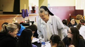 Sister Michael Marie Friedman laughs with volunteer Brandy Rothgerber, left, and the Confirmation participants during the morning session. Sister Michael Marie Friedman laughs with volunteer Brandy Rothgerber, left, and the Confirmation participants during the morning session.