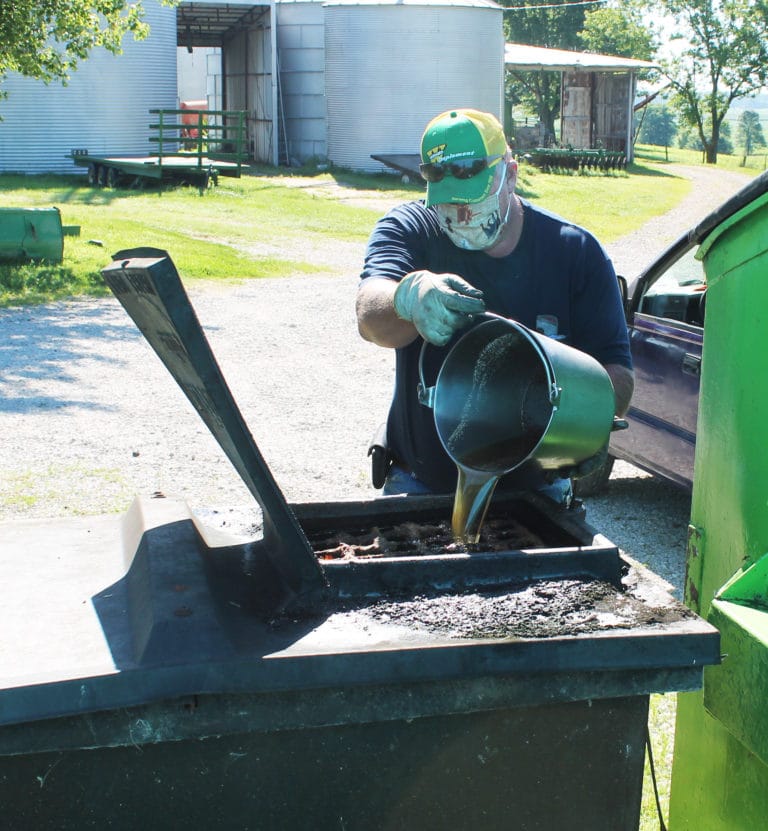 Maintenance worker Bryan Padgett pours used cooking oil into a receptacle to recycle. The Mount kitchen recycles oil and liquids used in the cleanup of dishes.