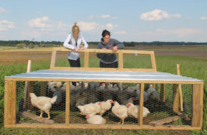 This chicken tractor was built by students in an agriculture maintenance class at Owensboro Community and Technical College, including these two, Emma Thrasher, left, and Erica May.