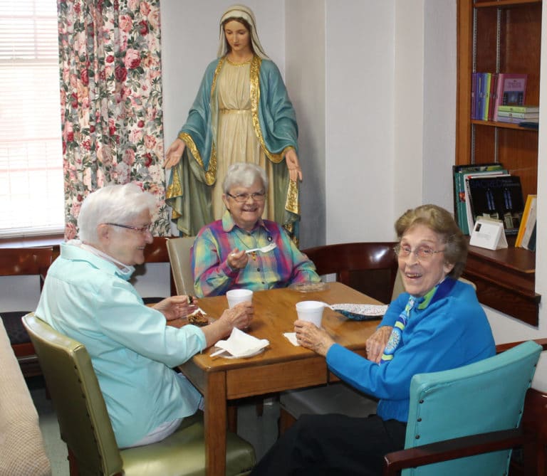 Sisters George Mary Hagan, left, Cecelia Joseph Olinger, center, and Elaine Burke enjoy some treats in the Lourdes Community Room in the morning.