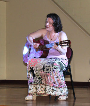 Lauren Calhoun plays the guitar and sings an Italian song to entertain the crowd. She has performed in plays for Theatre Workshop of Owensboro.