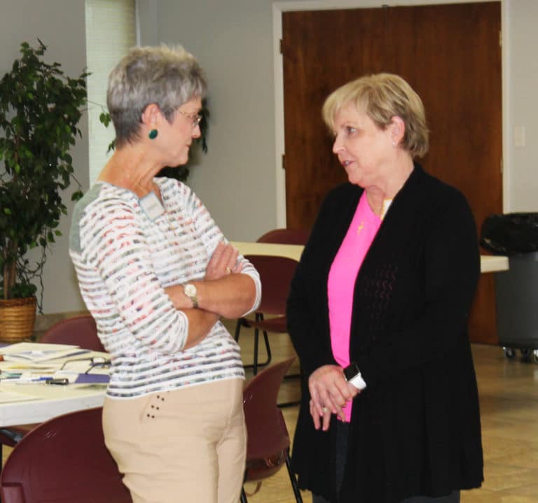 Carol Hulsey, right, a member of Our Lady of Lourdes Parish, talks with Stephanie Warren.
