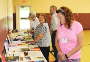 Ursuline Associates Marilyn Katzer, left, of Greeley, Kan., and Doreen Abbott, right, of Owensboro, Ky., look over the religious books that were free to the taker.
