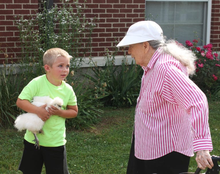 Sister Grace Swift talks with Emmitt Blakely, who is holding his silkie chicken. Emmitt celebrated his sixth birthday with the Sisters, who all sang “Happy Birthday” to him.