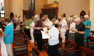 Ursuline Sisters rise and read their response to the Ursuline Associates recommitment.