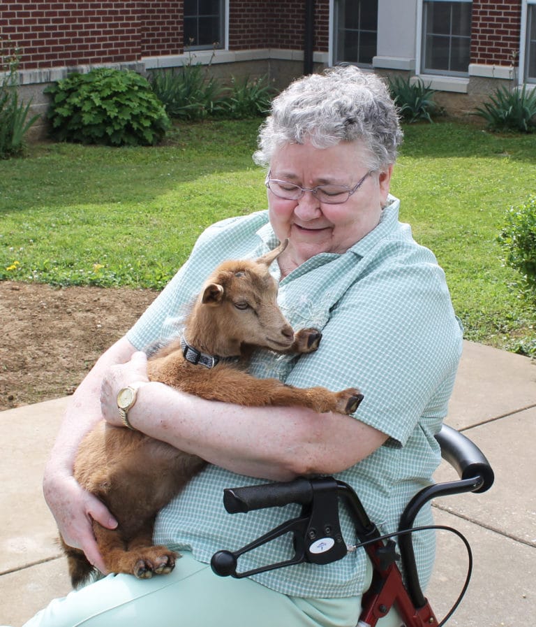 It looks like Sister Joyce Marie Cecil has made a friend for life with Flower the goat.