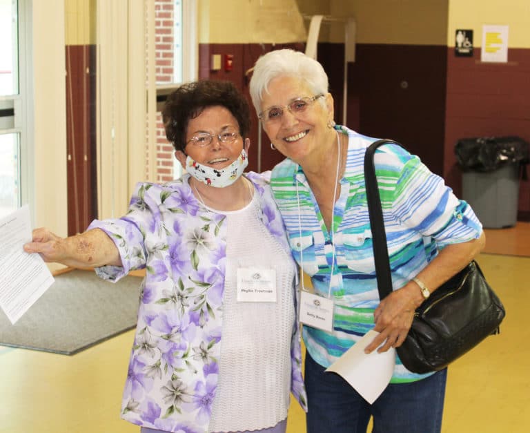 Associates Phyllis Troutman, left, and Betty Boren are all smiles as they arrive in the gym. “This is home,” Phyllis said.