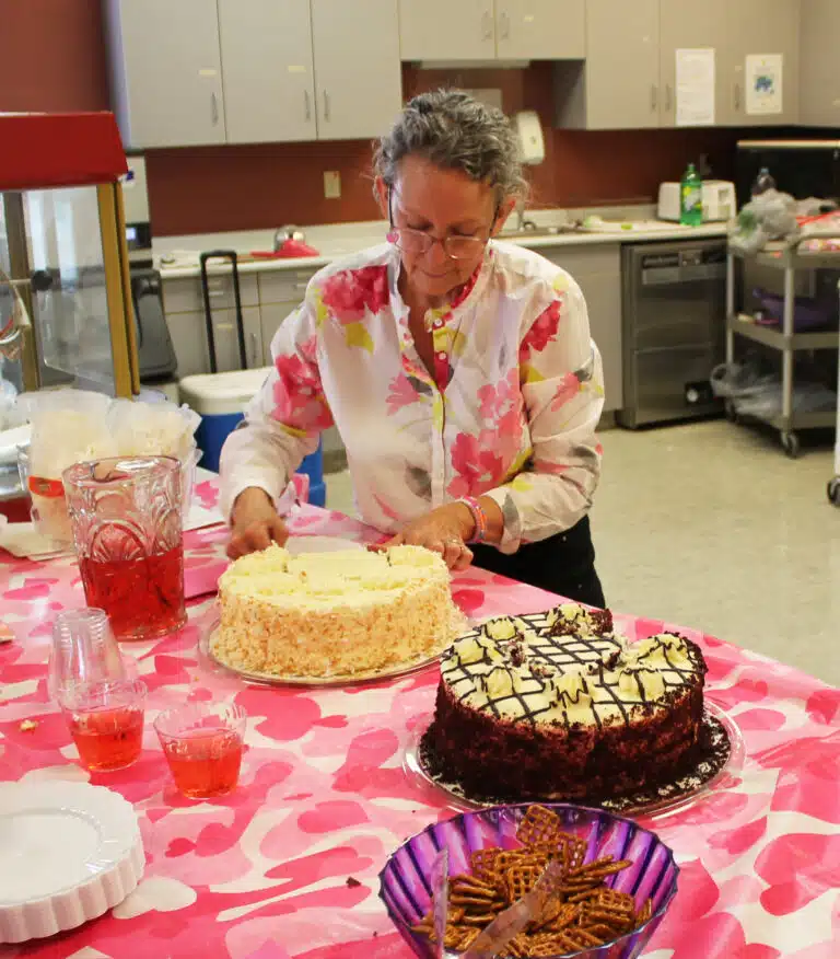 Ashley Wilkerson, coordinator of activities and pastoral care for the Sisters in Saint Joseph Villa, cuts a piece of Italian cream cake for the party. The Sisters also had the option of red velvet cake. Ashley Wilkerson, coordinator of activities and pastoral care for the Sisters in Saint Joseph Villa, cuts a piece of Italian cream cake for the party. The Sisters also had the option of red velvet cake.
