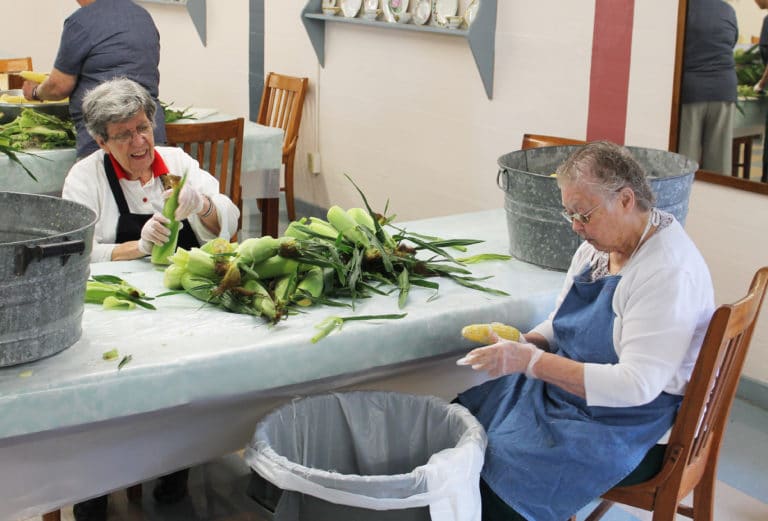 Sister Luisa Bickett, left, and Sister Marie Joseph Coomes imagine how good this corn is going to taste.