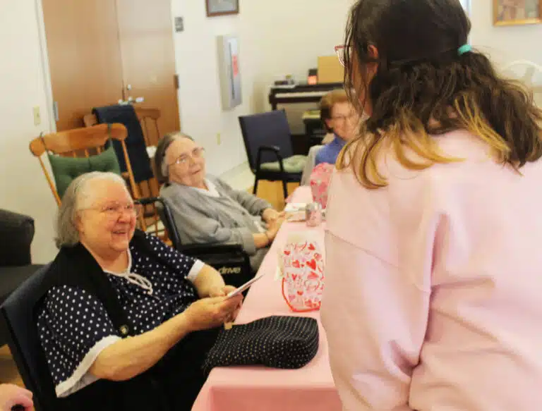 Sister Catherine Marie Lauterwasser is all smiles as she receives a Valentine from Linda Canales. Sister Catherine Marie Lauterwasser is all smiles as she receives a Valentine from Linda Canales.