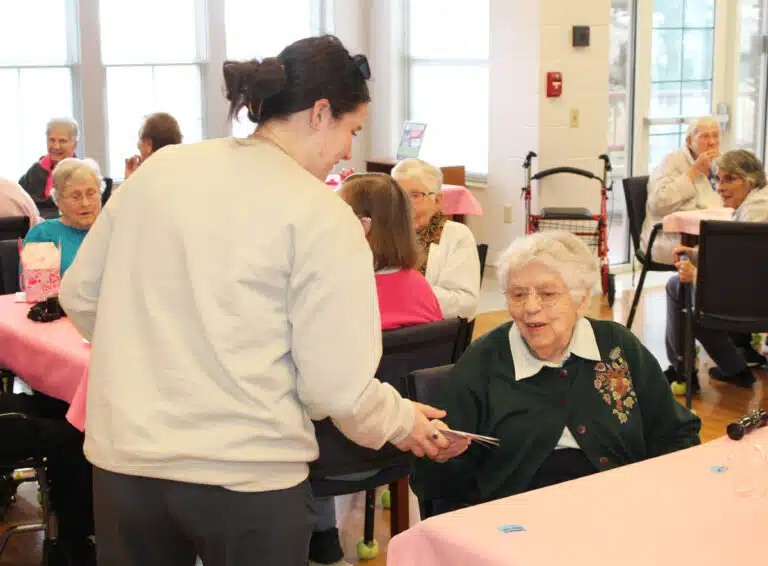 Sister Michael Ann Monaghan happily receives a Valentine card from Emma Wiles. Sister Michael Ann Monaghan happily receives a Valentine card from Emma Wiles.