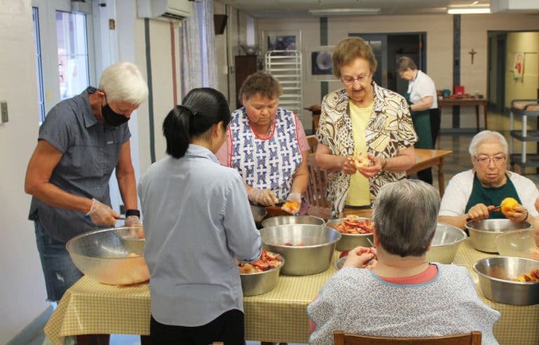 It was a well-oiled machine for this table of hard workers. From left, facing forward, are Associate Martha House, Sister Alicia Coomes, Sister Susan Mary Mudd and Sister Sara Marie Gomez.