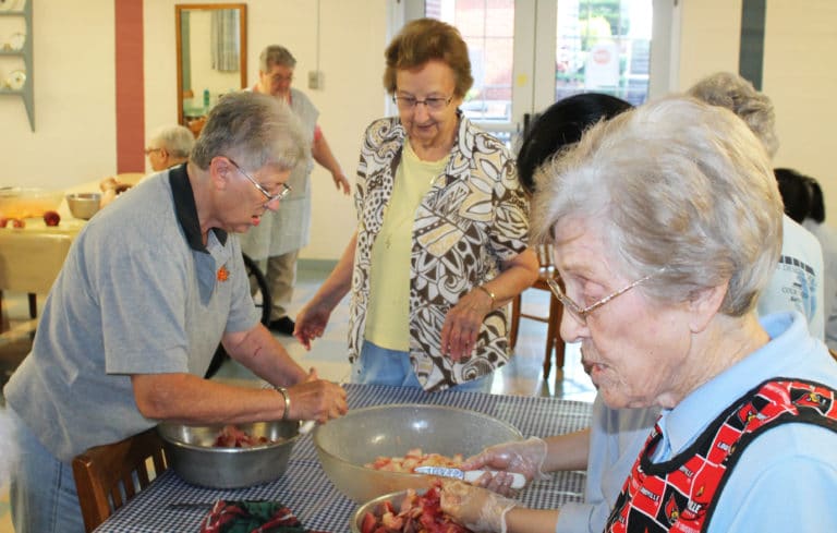 Sister Emma Anne Munsterman, left, Sister Susan Mary Mudd and Sister Elaine Burke put the finishing touches on their peach work.