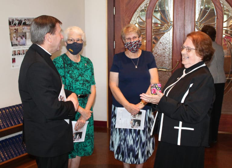 Sister Rosanne Spalding, right, shares a laugh before Mass in the vestibule of Precious Blood Church in Owensboro, Ky., with her nephew, Bishop Mark Spalding of Nashville, and Ursuline Sisters Barbara Jean Head, left, and Betsy Moyer.