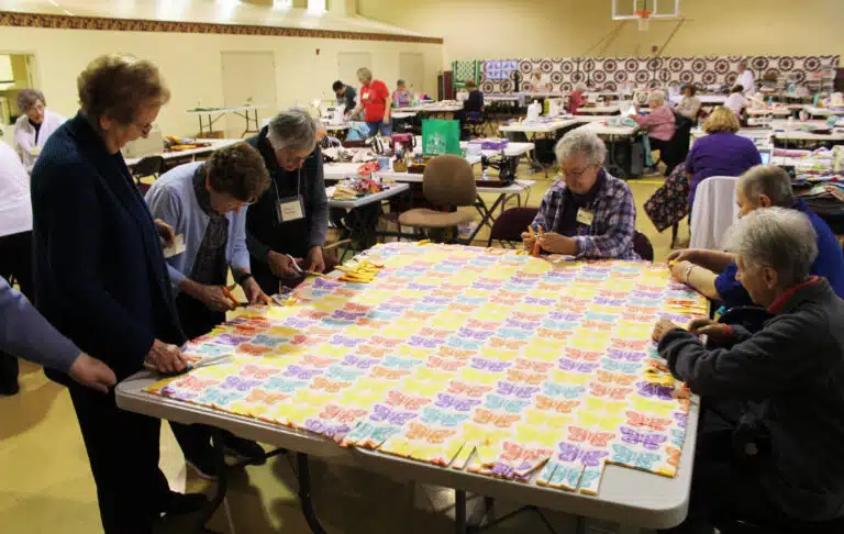 On March 10, Ursuline Associate Carolyn McCarty, third from left, joins the Ursuline Sisters in cutting strips of fabric to tie together to complete a blanket. The Sisters, from left, are Sister Susan Mary Mudd, Sister Mary Henning, Sister Michele Morek, Sister Kathleen Dueber and Sister Joan Riedley. On March 10, Ursuline Associate Carolyn McCarty, third from left, joins the Ursuline Sisters in cutting strips of fabric to tie together to complete a blanket. The Sisters, from left, are Sister Susan Mary Mudd, Sister Mary Henning, Sister Michele Morek, Sister Kathleen Dueber and Sister Joan Riedley.