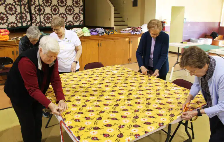 Participants cutting the sides of the blankets are, from left, Sister Suzanne Sims, Ursuline Associate Carolyn McCarty, Sister Amelia Stenger, Sister Susan Mary Mudd and Sister Mary Henning. Sister Amelia coordinated the event. Participants cutting the sides of the blankets are, from left, Sister Suzanne Sims, Ursuline Associate Carolyn McCarty, Sister Amelia Stenger, Sister Susan Mary Mudd and Sister Mary Henning. Sister Amelia coordinated the event.