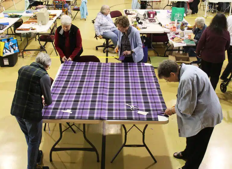 Sister Sharon Sullivan, right, joins Ursuline Associate Carolyn McCarty, left, and Sisters Suzanne Sims and Mary Henning on this purple blanket. Sister Sharon Sullivan, right, joins Ursuline Associate Carolyn McCarty, left, and Sisters Suzanne Sims and Mary Henning on this purple blanket.