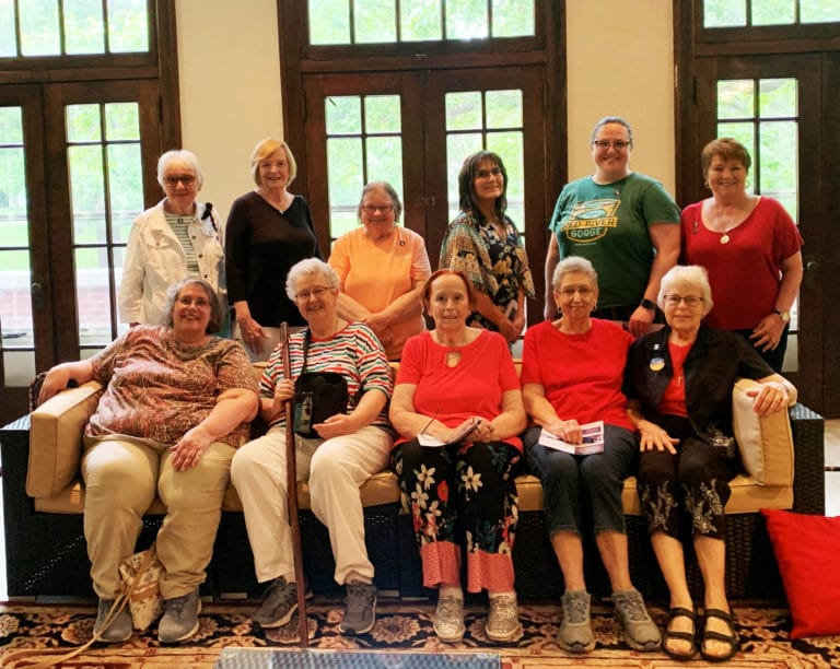 Associates and Sisters gather in the former Wicker Room at the convent for a photo. Seated from left are Associate Joanne Thompson, Sister Michele Morek, Associate Karen Feehan, Associate Mary Ann Stewart, and Sister Angela Fitzpatrick; standing from left are Associates Janice Arth, Jean Vanderheiden, Pam Knudson, Nanette Foley, Renee Schultz and Carol O'Keefe.