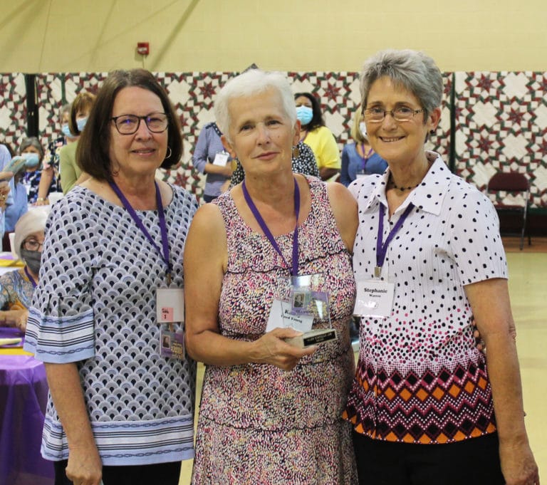 Maple Leaf Award winner Kathy Ford Young, A70, center, poses with one of her nominators, her classmate Rebecca Henderson McCarty, left, and Stephanie Warren, Alumnae Association president.