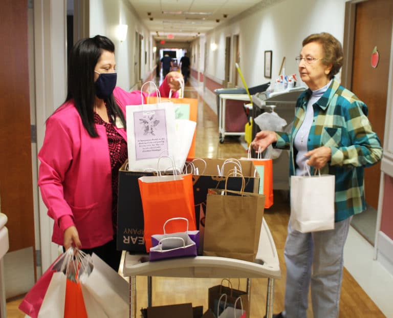 Pamela Paulin, left, staff administrator in Saint Joseph Villa, and Sister Susan Mary Mudd disseminate the goody bags to each Sister’s room.