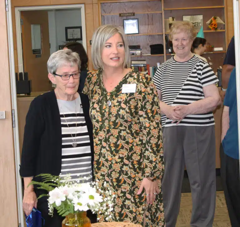 Amanda Morris, vice president of Academic Affairs and Academic Dean at Brescia, hugs Sister Judith Nell as she opens the retirement ceremony. To the right is Sister Helena Fischer, the registrar. Amanda Morris, vice president of Academic Affairs and Academic Dean at Brescia, hugs Sister Judith Nell as she opens the retirement ceremony. To the right is Sister Helena Fischer, the registrar.