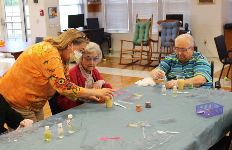 Debbie Dugger, left, activities coordinator for the Sisters in the Villa, helps Sister Mary Gerald Payne with her soap mixture, as Sister Sara Marie Gomez works on her creation.