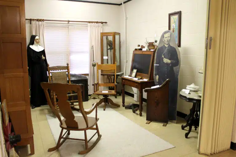 Father Volk's life-size image is next to his desk. Father Volk's life-size image is next to his desk.