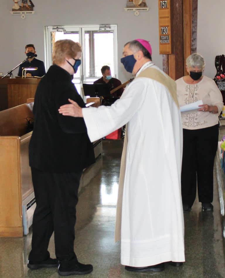 Bishop Medley congratulates Sister Helena Fischer, celebrating 60 years in 2021. At right is Ursuline Sister Mary Celine Weidenbenner, who was dispensing the certificates.