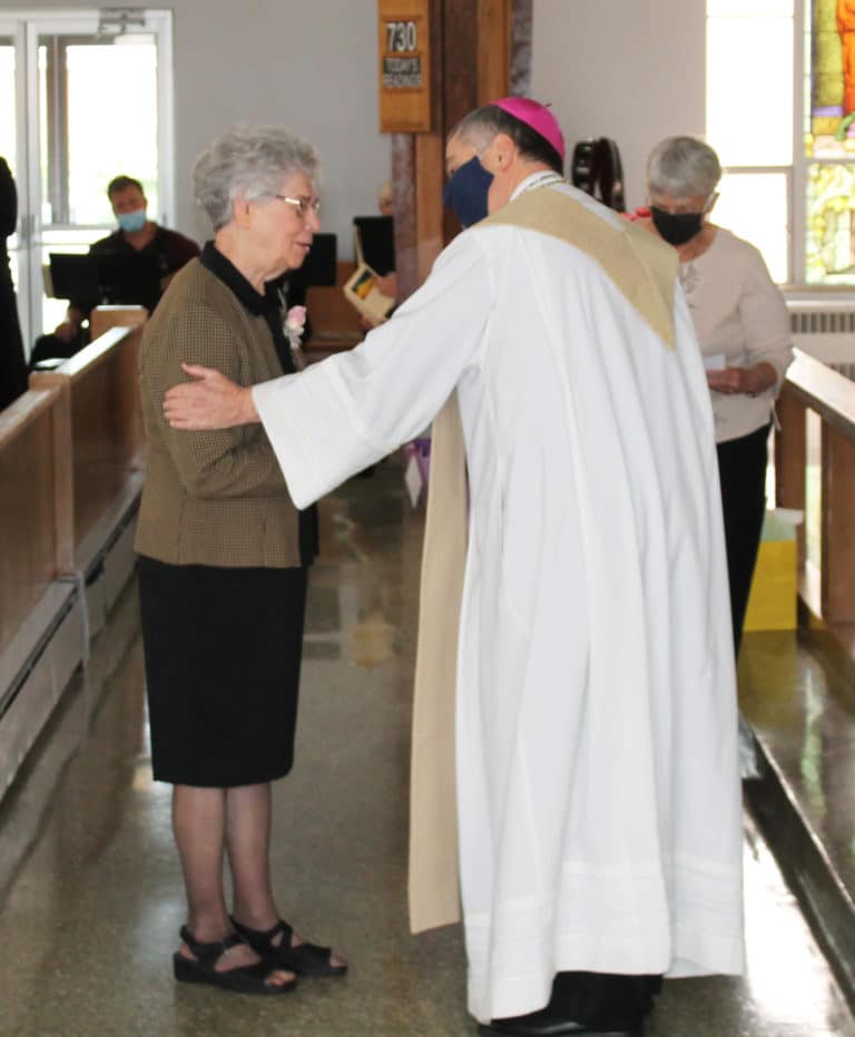 Sister Nancy Murphy accepts her congratulations from the bishop. She is celebrating 60 years in 2021.