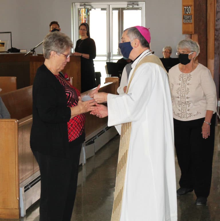 Sister Betsy Moyer receives congratulations from Bishop Medley for celebrating 50 years in 2021.