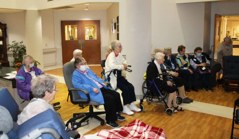 Many Sisters gathered in the lobby of Saint Joseph Villa for the ceremony. From left are Sisters Rose Karen Johnson, Marie Joseph Coomes, Paul Marie Greenwell, George Mary Hagan, Margaret Marie Greenwell, Cecelia Joseph Olinger (partially hidden), Clarita Browning, Marie Goretti Browning (partially hidden), Mary Gerald Payne, Susan Mary Mudd, Alicia Coomes and Grace Swift.