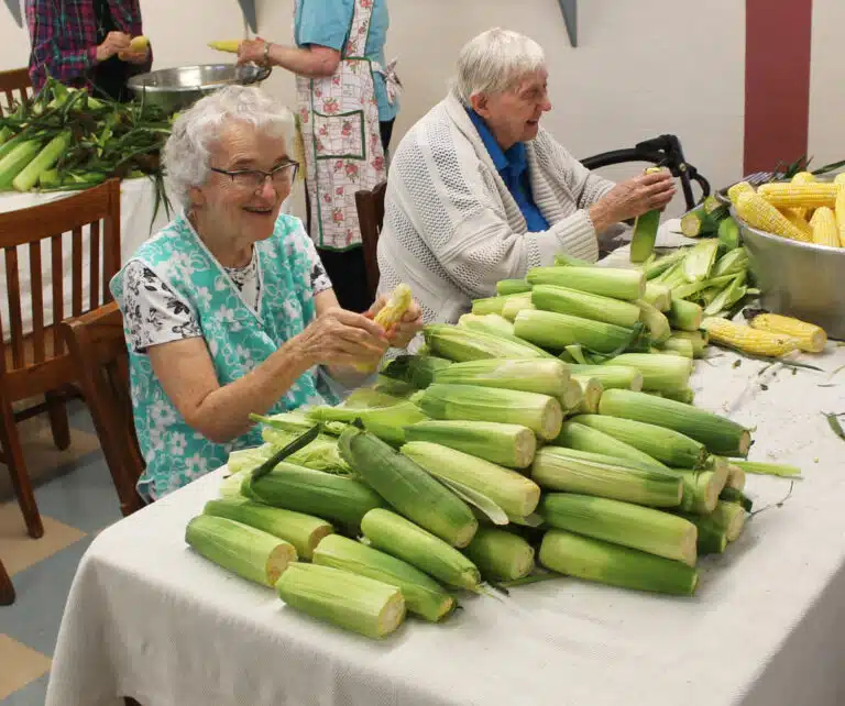 Sister Ann Patrice Cecil, left, and Sister Grace Simpson are undaunted by the stack of corn they need to shuck. Sister Ann Patrice Cecil, left, and Sister Grace Simpson are undaunted by the stack of corn they need to shuck.