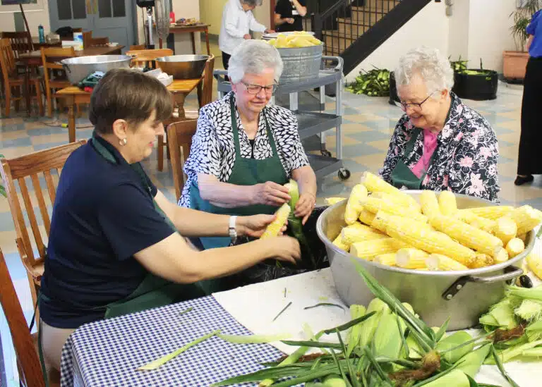 Amy Fogle Stiff, left, the new director of Local Community Life, works side by side with Sister Mary Timothy Bland, center, and Sister Michele Morek to fill their pan. Amy Fogle Stiff, left, the new director of Local Community Life, works side by side with Sister Mary Timothy Bland, center, and Sister Michele Morek to fill their pan.