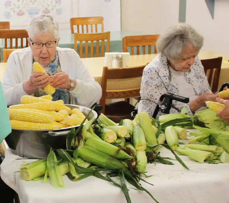 Sister Ruth Gehres, left, and Sister Catherine Barber get those last silks off their ears of corn. Sister Ruth Gehres, left, and Sister Catherine Barber get those last silks off their ears of corn.