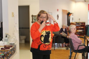Debbie Dugger, activities coordinator for the sisters in Saint Joseph Villa, is cat-tastic in her sweater.