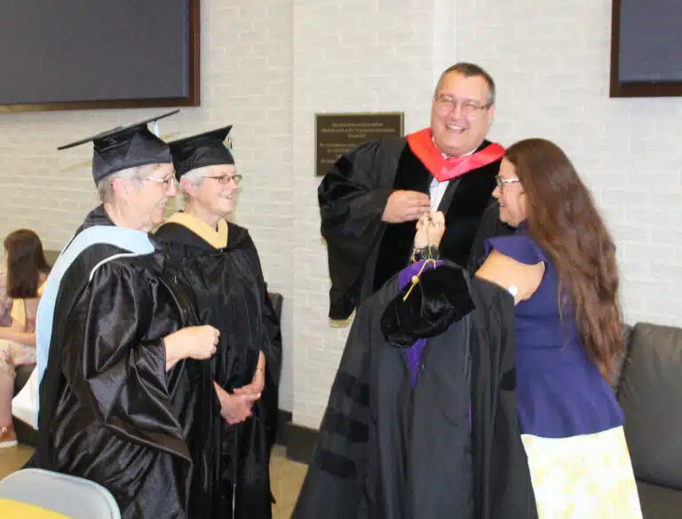 Sister Betsy Moyer, left, and Sister Barbara Jean Head, dressed in their formal garb, talk with Michael Lamar and Susan Montalvo-Gesser in the Moore Center prior to the inauguration. Sister Betsy serves in the Education Department at Brescia, and Sister Barbara Jean is a senior accountant at the college. Lamar is a longtime friend of Madison Silvert, and Montalvo-Gesser is chairwoman of the Brescia Board of Directors. Sister Betsy Moyer, left, and Sister Barbara Jean Head, dressed in their formal garb, talk with Michael Lamar and Susan Montalvo-Gesser in the Moore Center prior to the inauguration. Sister Betsy serves in the Education Department at Brescia, and Sister Barbara Jean is a senior accountant at the college. Lamar is a longtime friend of Madison Silvert, and Montalvo-Gesser is chairwoman of the Brescia Board of Directors.