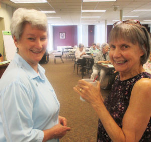 Sister Pam Mueller, left, and Sister Kathleen Kaelin share a laugh in the Saint Angela room of the Conference and Retreat Center.