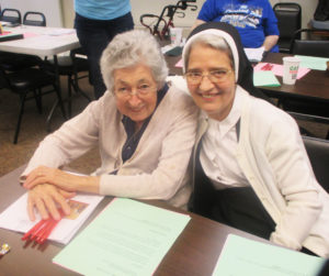 Sister Teresa Riley, left, and Sister Rose Karen Johnson enjoy time at their table on July 13.