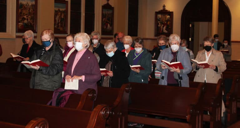 The Ursuline Sisters represented the largest group present at the Mass. Here they sing the opening hymn. From right are Sisters Amelia Stenger, Pat Lynch, Betsy Moyer, Jacinta Powers, Barbara Jean Head, Mary Celine Weidenbenner, Mary Timothy Bland, Vivian Bowles, Marie Joseph Coomes (partially hidden), Rebecca White, Alicia Coomes (partially hidden) and Helena Fischer.