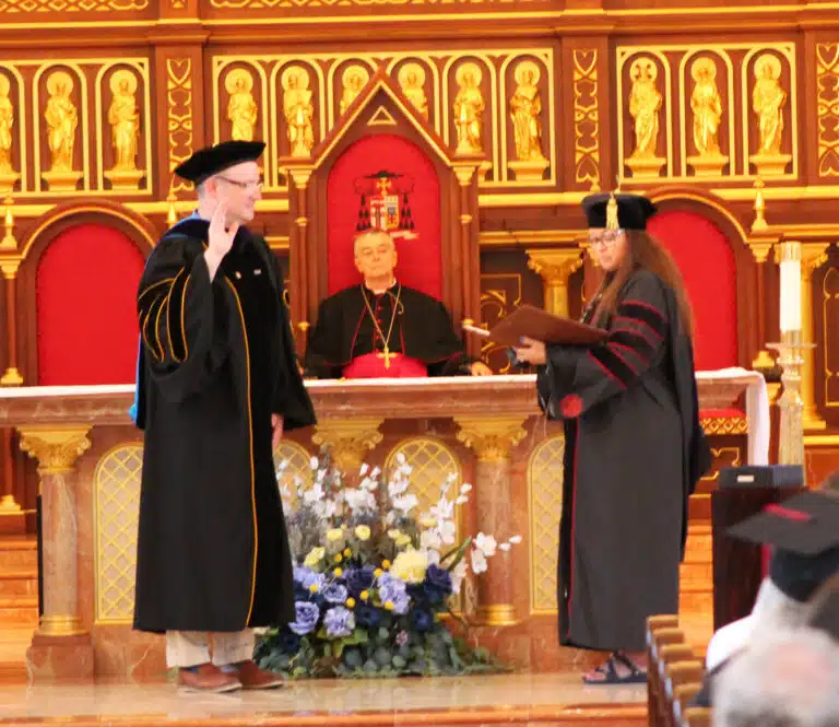 Susan Montalvo-Gesser, chairwoman of the Brescia Board of Directors, administers the oath of office to Madison Silvert as Brescia’s sixth president. In the back is Bishop William Medley. Susan Montalvo-Gesser, chairwoman of the Brescia Board of Directors, administers the oath of office to Madison Silvert as Brescia’s sixth president. In the back is Bishop William Medley.