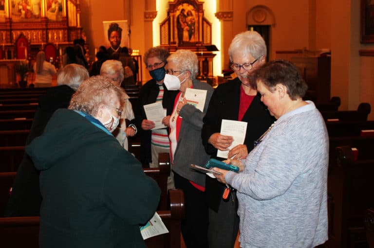 Following Mass, Ursuline Sisters Marie Joseph Coomes, left, and Alicia Coomes chat with Kathy Doup, a longtime friend of the Sisters. In the background are Sisters Betsy Moyer and Barbara Jean Head.