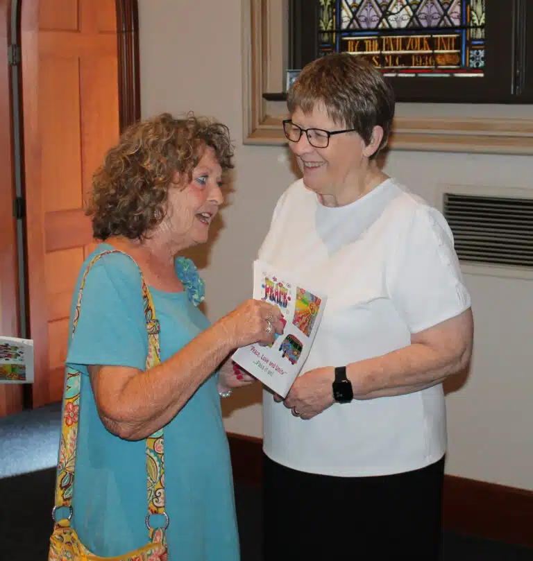 Mary Margaret Drury A’66, left, says something to make Sister Amelia Stenger ‘A67 laugh prior to Mass. Mary Margaret Drury A’66, left, says something to make Sister Amelia Stenger ‘A67 laugh prior to Mass.
