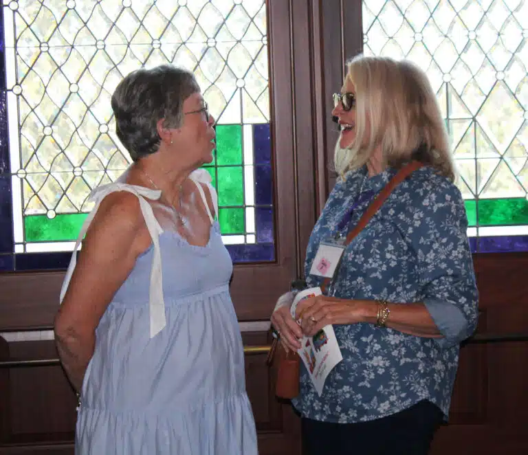 Paula Chandler Gray, left, talks to her 1973 classmate Rhonda Warren Mischel as she welcomes people to Mass. Paula Chandler Gray, left, talks to her 1973 classmate Rhonda Warren Mischel as she welcomes people to Mass.