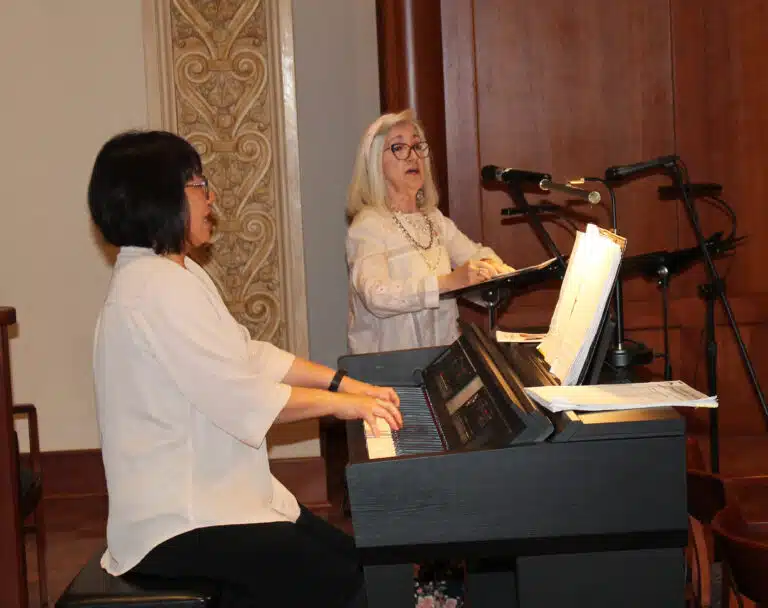 Jenny Speaks McGee A’70, cantors as Sharon Hudson plays piano during “Gather the People” to open Mass. Hudson’s husband works in information services at the Mount. Jenny Speaks McGee A’70, cantors as Sharon Hudson plays piano during “Gather the People” to open Mass. Hudson’s husband works in information services at the Mount.