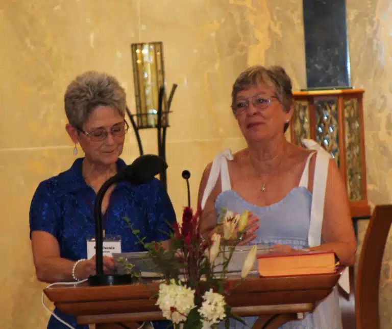 Stephanie Warren A’73, left, alumnae president, and Paula Chandler Gray A’73, treasurer, read the names of alumnae whose deaths were reported in the previous year. Stephanie Warren A’73, left, alumnae president, and Paula Chandler Gray A’73, treasurer, read the names of alumnae whose deaths were reported in the previous year.
