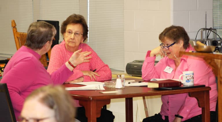 Sister Melissa Tipmore, left, makes a point to Sister Susan Mary Mudd, center, and Sister Alicia Coomes.