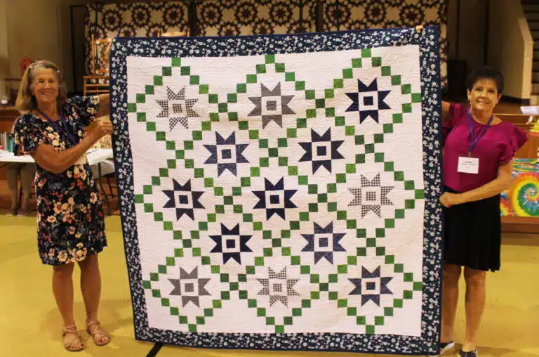 Among the many fabulous raffle prizes was this quilt made by Karen Calhoun McCarty A’74, right, and won by Carole Caummisar Sanders A’68, left. Among the many fabulous raffle prizes was this quilt made by Karen Calhoun McCarty A’74, right, and won by Carole Caummisar Sanders A’68, left.