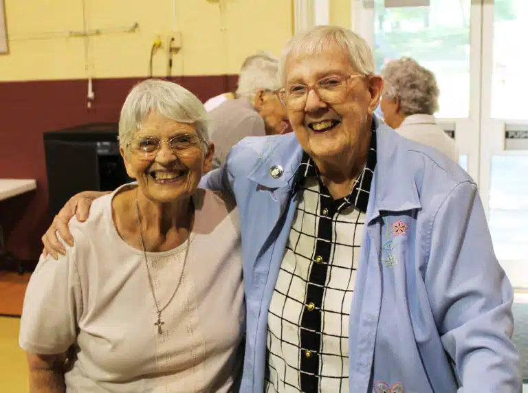 Sister Mary Celine Weidenbenner A’62, gets a hug from her prayer partner, Sister Grace Simpson A’56. Sister Mary Celine Weidenbenner A’62, gets a hug from her prayer partner, Sister Grace Simpson A’56.
