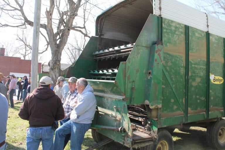 Farm auctions are a great place to socialize, as these men prove.