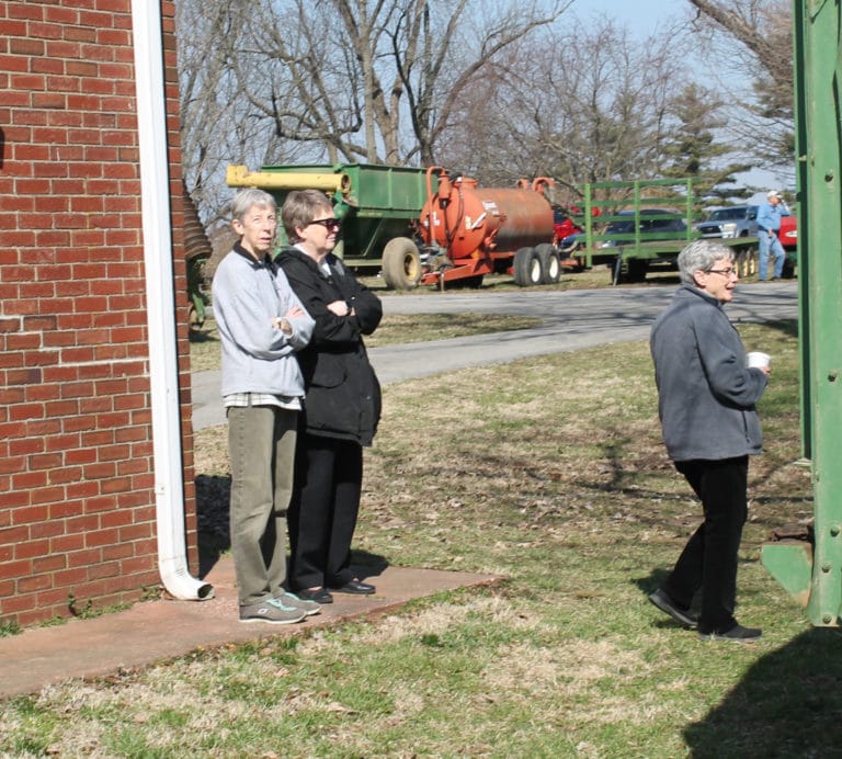 From left, Sisters Maureen O’Neill, Amelia Stenger and Judith Nell Riney watch the auctioneers at work.